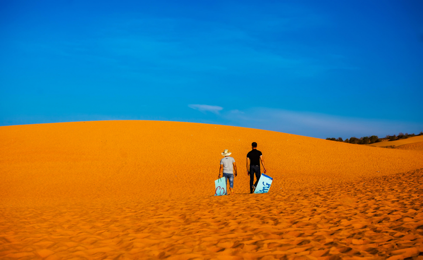 Go sandboarding on the red dunes of Mui Ne